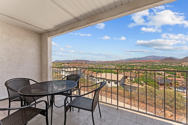 balcony featuring a residential view and a mountain view