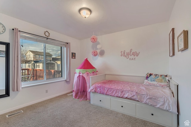 carpeted bedroom featuring baseboards and visible vents