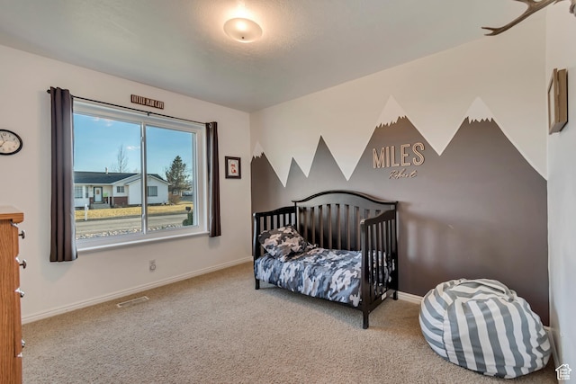 carpeted bedroom featuring baseboards and visible vents