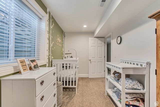 bedroom with visible vents, baseboards, recessed lighting, light carpet, and a nursery area
