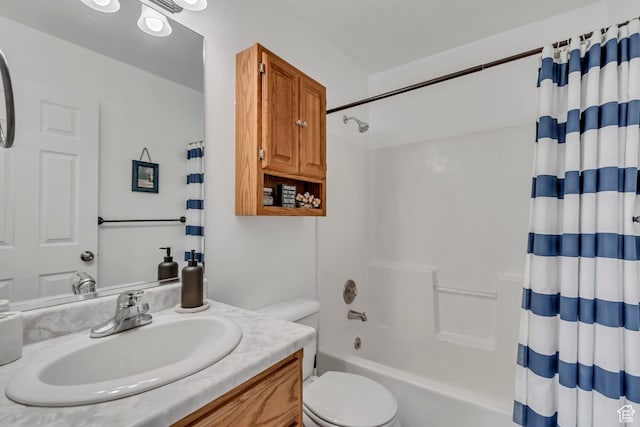 full bath featuring toilet, shower / bath combo with shower curtain, and vanity