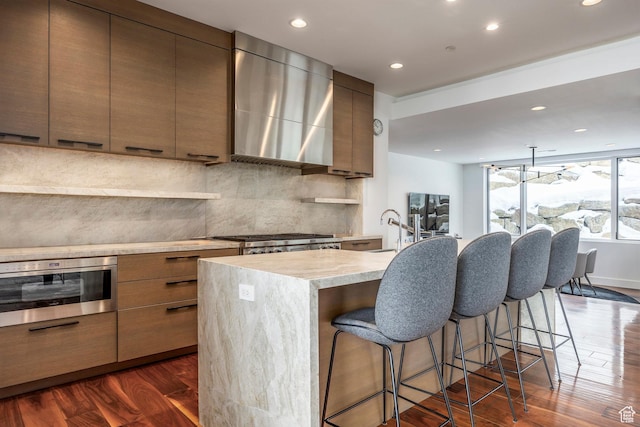 2908 W Deer Pointe Dr, Heber City, UT 84032 - kitchen with modern cabinets, wall chimney exhaust hood, appliances with stainless steel finishes, and dark wood-type flooring