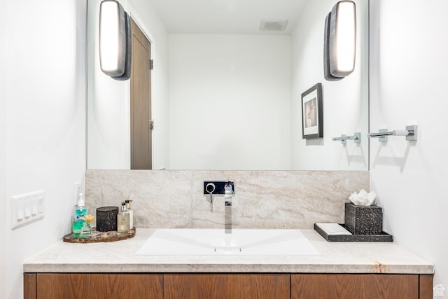 2908 W Deer Pointe Dr, Heber City, UT 84032 - bathroom with visible vents, vanity, and tasteful backsplash