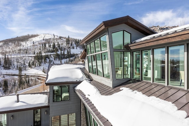 2908 W Deer Pointe Dr, Heber City, UT 84032 - view of snowy exterior with a sunroom and a mountain view