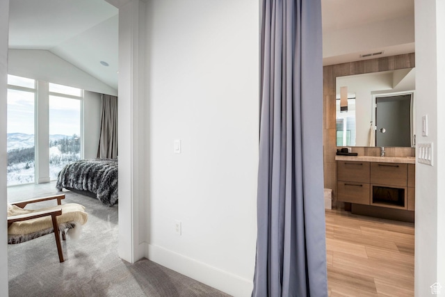 2908 W Deer Pointe Dr, Heber City, UT 84032 - hall with vaulted ceiling, a sink, baseboards, visible vents, and a mountain view