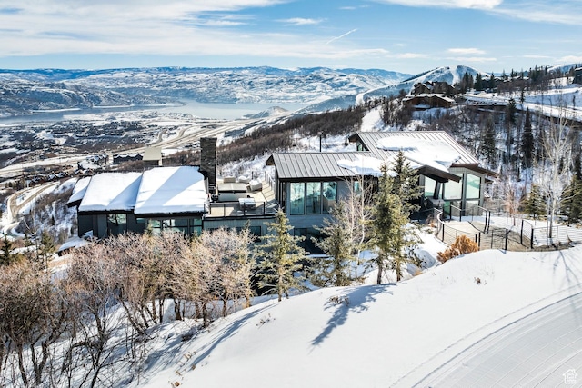 snowy aerial view with a mountain view