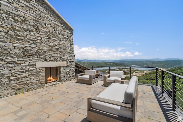 2908 W Deer Pointe Dr, Heber City, UT 84032 - view of patio / terrace with an outdoor living space with a fireplace and a water view