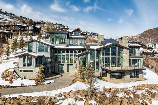 2908 W Deer Pointe Dr, Heber City, UT 84032 - snow covered house featuring a sunroom and a chimney