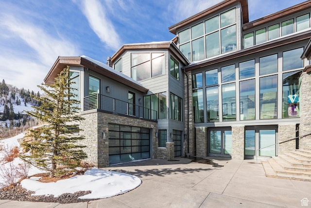 2908 W Deer Pointe Dr, Heber City, UT 84032 - rear view of property with stone siding and a garage
