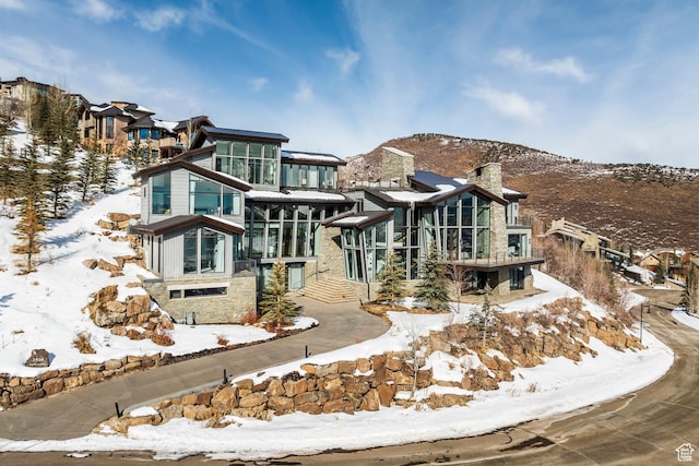 2908 W Deer Pointe Dr, Heber City, UT 84032 - view of front facade featuring a sunroom and a chimney