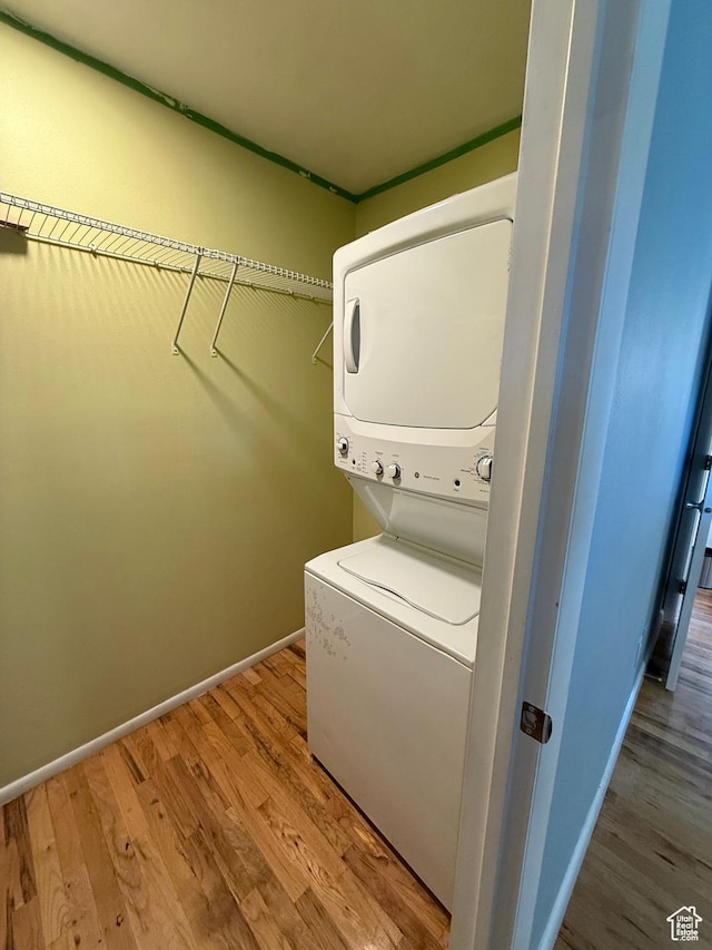 650 N 300 W Unit 234, Salt Lake City, UT 84103 - washroom featuring stacked washer / dryer, baseboards, and wood finished floors