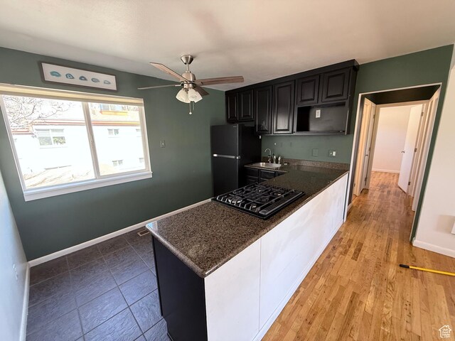 650 N 300 W Unit 234, Salt Lake City, UT 84103 - kitchen featuring black gas stovetop, a sink, freestanding refrigerator, baseboards, and ceiling fan