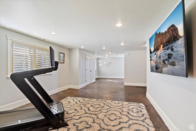 exercise area with baseboards and recessed lighting