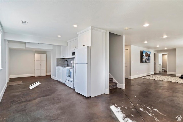 kitchen with a sink, white cabinetry, baseboards, white appliances, and recessed lighting