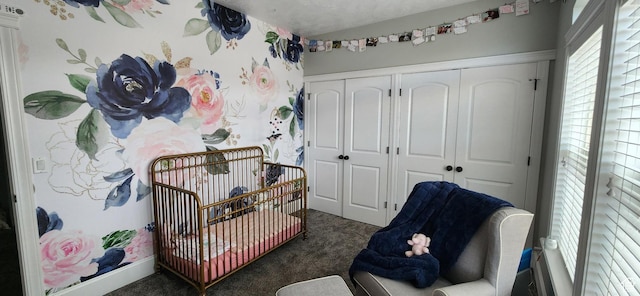 bedroom with a closet, wallpapered walls, and carpet