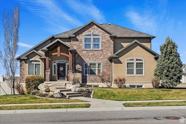view of front of home featuring stucco siding, stone siding, and a front lawn