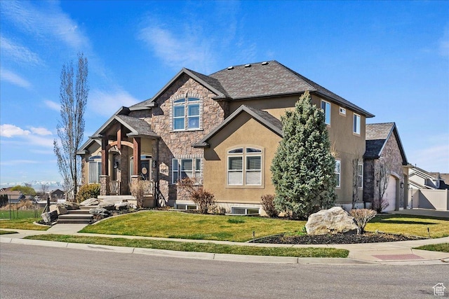 view of front of home with a front yard, an attached garage, stone siding, and stucco siding