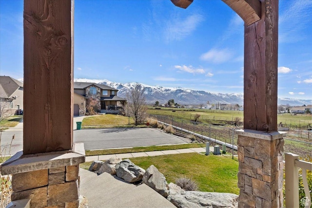 view of yard with fence, a rural view, and a mountain view