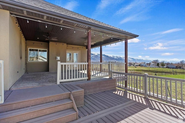 deck featuring ceiling fan and a mountain view