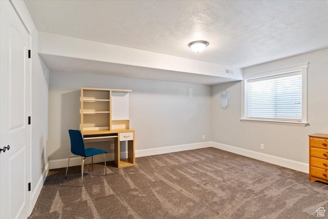 office space featuring baseboards, visible vents, dark colored carpet, and a textured ceiling