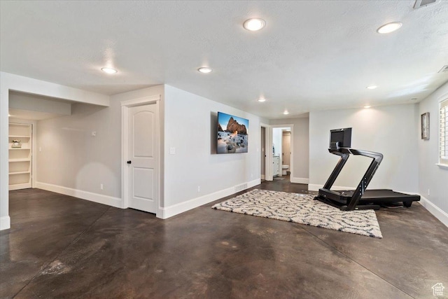 workout room with baseboards, a textured ceiling, and recessed lighting