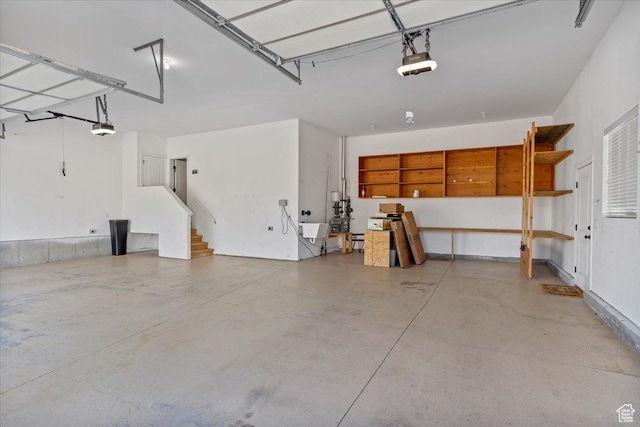 garage with a sink, electric panel, and a garage door opener