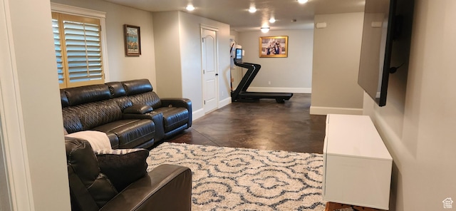 living room with concrete floors and baseboards