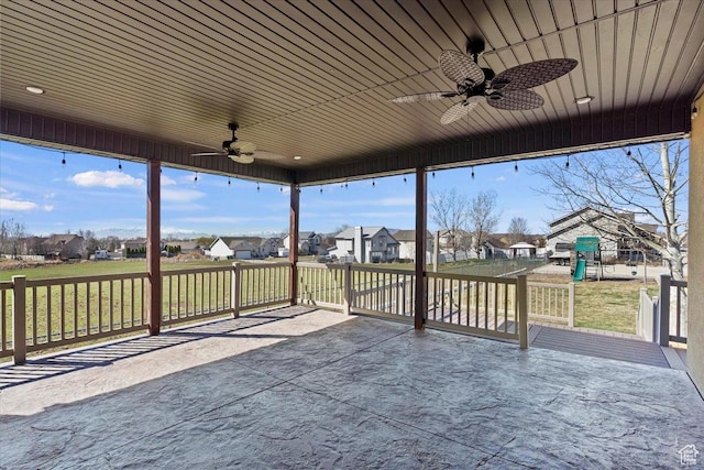 wooden deck with a residential view, a lawn, ceiling fan, and a playground