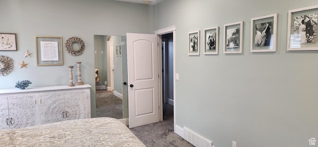 carpeted bedroom featuring baseboards and visible vents