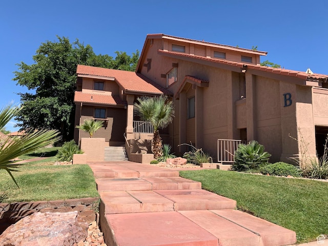 view of front of home featuring stucco siding and a tile roof