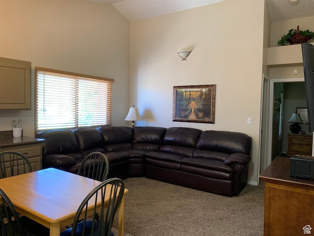 living room featuring carpet floors and lofted ceiling