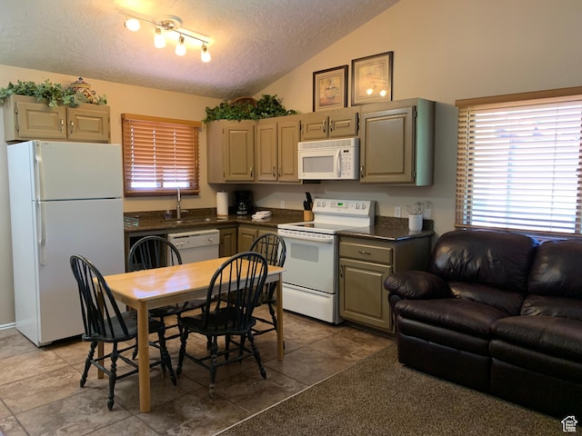 kitchen with lofted ceiling, a sink, dark countertops, and white appliances