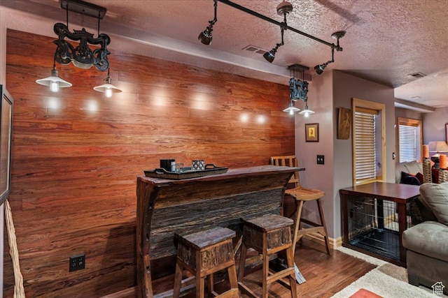 3594 E 3800 S, Salt Lake City, UT 84109 - bar featuring a textured ceiling, wood walls, visible vents, a dry bar, and wood finished floors