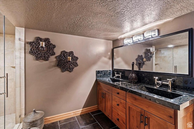 3594 E 3800 S, Salt Lake City, UT 84109 - bathroom featuring a sink, tiled shower, double vanity, and a textured ceiling