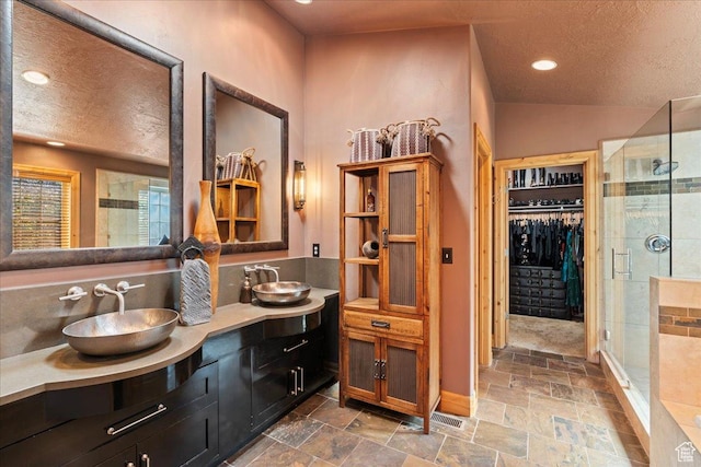 3594 E 3800 S, Salt Lake City, UT 84109 - bathroom featuring a shower stall, a spacious closet, a textured ceiling, and a sink