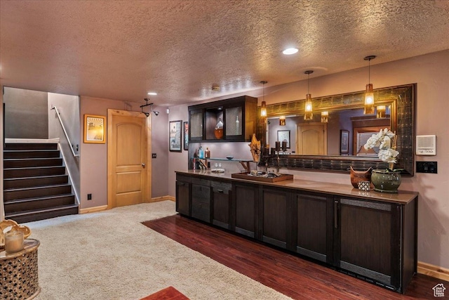 3594 E 3800 S, Salt Lake City, UT 84109 - bar featuring hanging light fixtures, baseboards, dark wood-style floors, a textured ceiling, and stairway