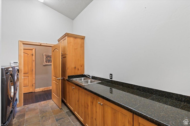 3594 E 3800 S, Salt Lake City, UT 84109 - laundry area featuring separate washer and dryer, stone finish flooring, a sink, baseboards, and cabinet space