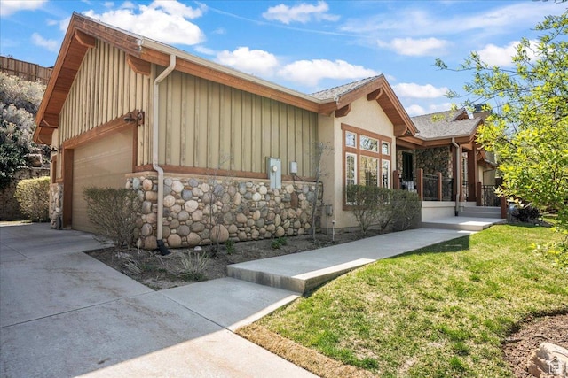 3594 E 3800 S, Salt Lake City, UT 84109 - view of home's exterior featuring board and batten siding, a garage, and stone siding