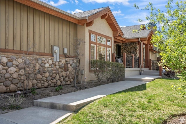 3594 E 3800 S, Salt Lake City, UT 84109 - exterior space featuring a shingled roof, stucco siding, stone siding, and a lawn