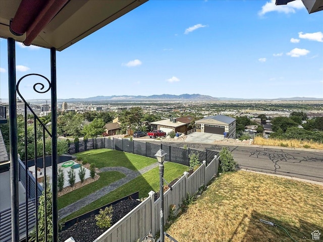 view of yard featuring fence and a mountain view