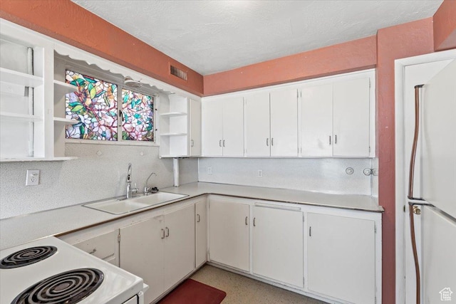 kitchen with white cabinetry, light countertops, open shelves, white appliances, and a sink