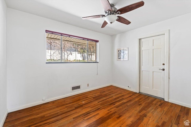 unfurnished bedroom featuring baseboards, visible vents, wood finished floors, and a ceiling fan