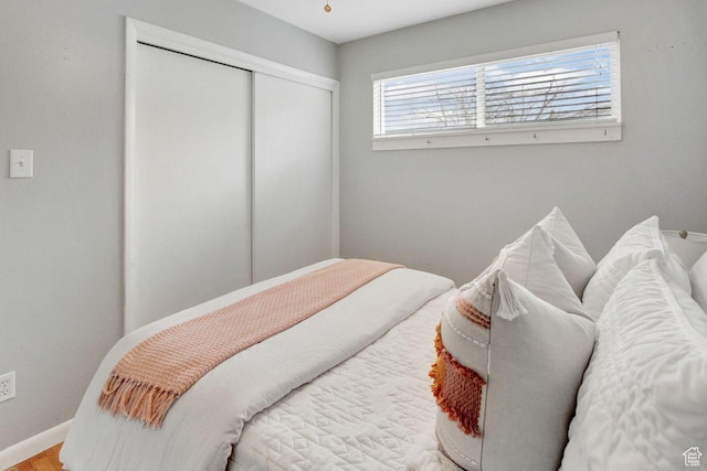 650 N 300 W Unit 202, Salt Lake City, UT 84103 - bedroom featuring baseboards, a closet, and wood finished floors