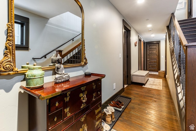 hall with hardwood / wood-style floors, baseboards, stairway, and recessed lighting