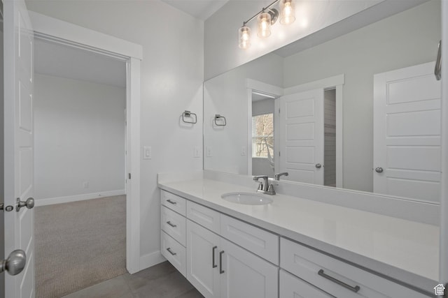 bathroom featuring baseboards and vanity