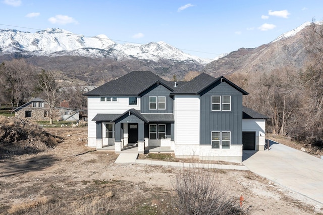 view of front of property featuring covered porch, a mountain view, and concrete driveway