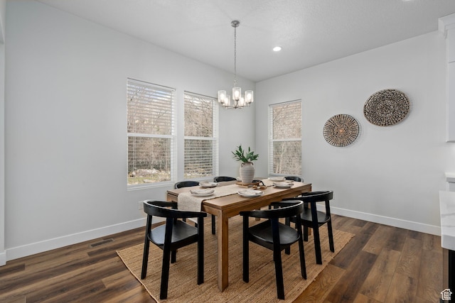 dining area with dark wood-type flooring, baseboards, and visible vents