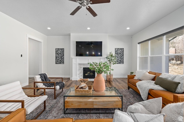 living area with wood finished floors, recessed lighting, and ceiling fan