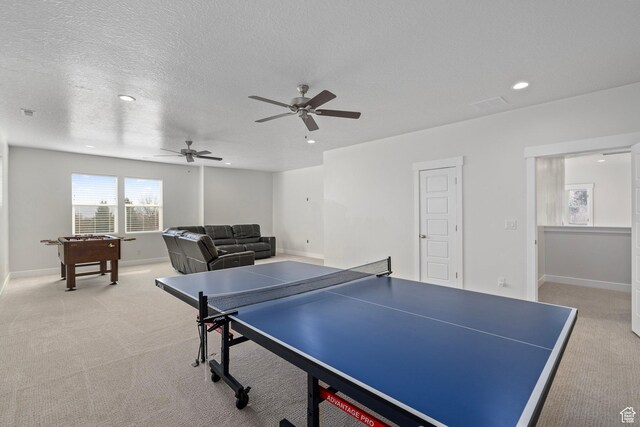 rec room featuring light carpet, ceiling fan, recessed lighting, and a textured ceiling