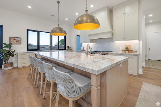 775 W 1300 S, Hurricane, UT 84737 - kitchen featuring custom range hood, tasteful backsplash, recessed lighting, a large island, and light stone counters